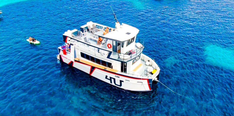 Big white catamaran in Adriatic sea, named 4U